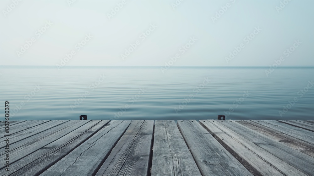 An old weathered dock over a peaceful ocean, evoking a sense of quiet and stillness An old weathered dock over a peaceful ocean, evoking a sense of quiet and stillness