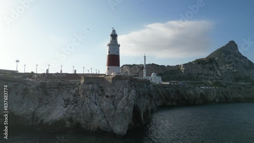 A beautiful 4k, low flying reverse tracking shot from cliffs in Gibraltar below it's lighthouse.
