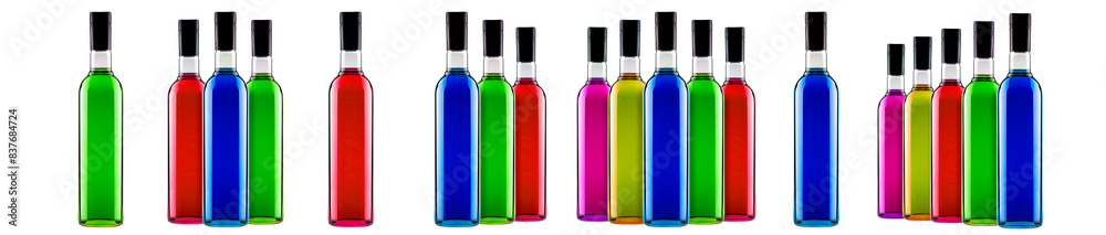 A collection of colorful glass bottles with vibrant hues and black caps, arranged neatly in a row