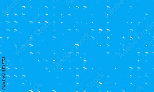 Seamless background pattern of evenly spaced white umbrella symbols of different sizes and opacity. Vector illustration on light blue background with stars