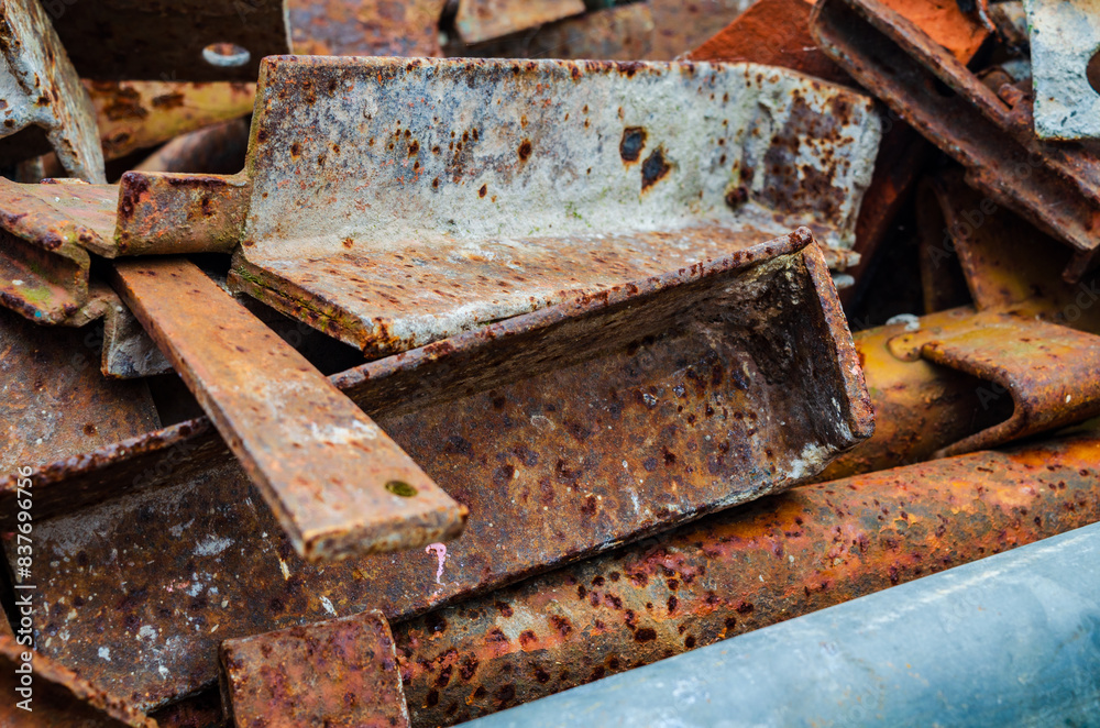 Rusted metal scaffolding piled up waiting to be dumped or recycled Rusted metal scaffolding piled up waiting to be dumped or recycled