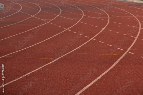 A track with white lines and red background