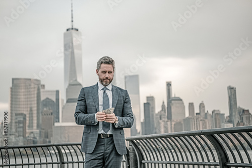 Business in USA. Business man with money dollars in New York. Money Concept. American dollars. Businessman make money. Dollar bill, easy money in NYC. Lucky mature millennial hispanic businessman.