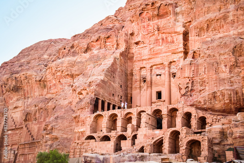 Tourist stand by Royal tombs structures in ancient city of Petra, Jordan. UNESCO World Heritage Site