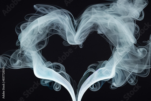 smoky heart. beautiful heart made of gray smoke on a black background. aesthetics and love concept