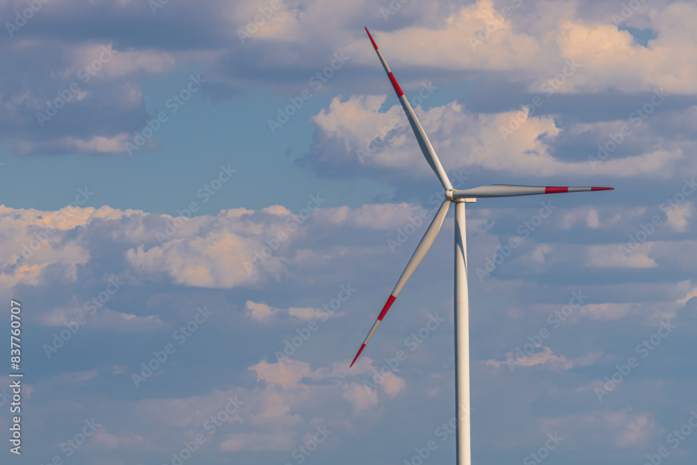 Wind turbine on wind farm with beautiful clouds in background Wind turbine on wind farm with beautiful clouds in background