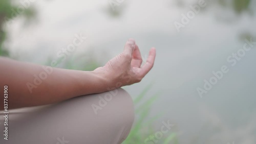 Wallpaper Mural Close-up the hands of a young man who loves good health. Meditating beside the lake He is surrounded by beautiful nature. healthy lifestyle Zen Buddhism How to meditate, yoga Torontodigital.ca