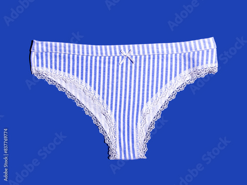 Blue and white striped female underwear on blue background photo