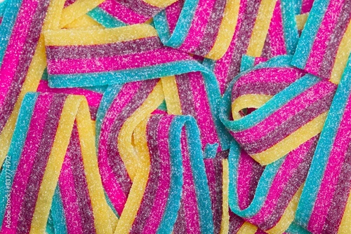 Close-up of Sour jelly candy strips in rainbow colors.