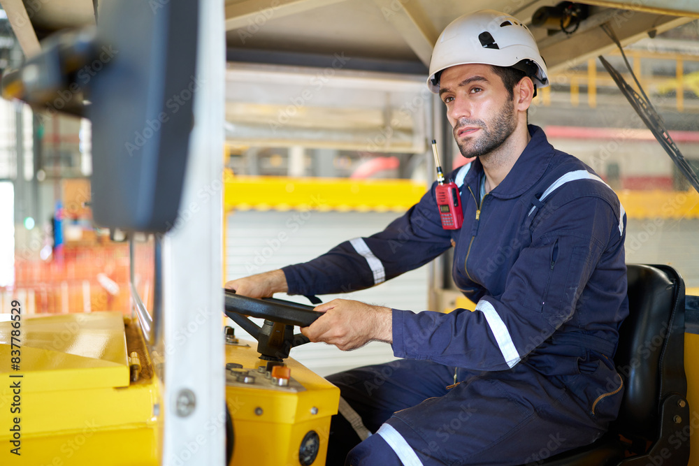 Engineer or worker driving a car in the factory Engineer or worker driving a car in the factory