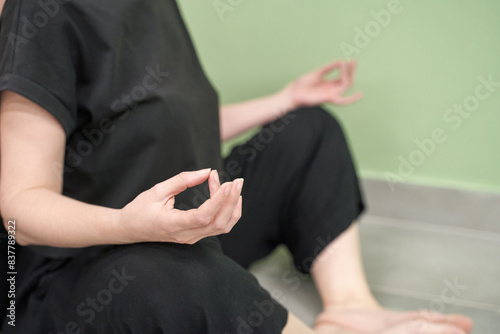 Yoga calm pose. Zen hand mudra. Lotus asana at studio training. Woman seating at floor. Beginner class room. Female morning exercise workout. Relax balance meditation symbol. © elenavolf