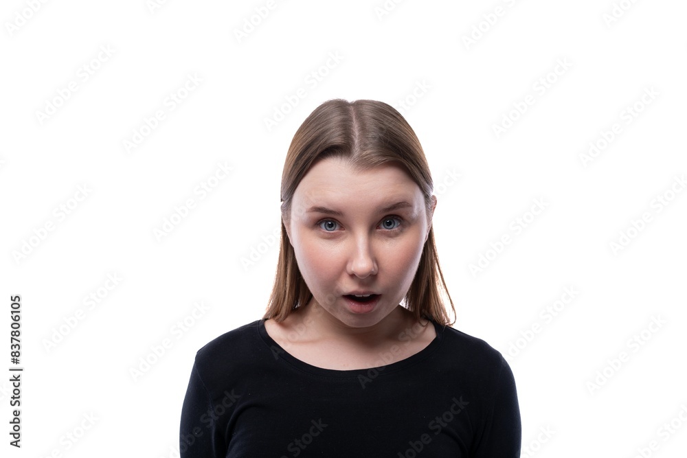Emotional portrait of a schoolgirl with blond hair in a black turtleneck on a white background Emotional portrait of a schoolgirl with blond hair in a black turtleneck on a white background