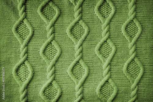 green background knitted fabric with arana pattern close-up