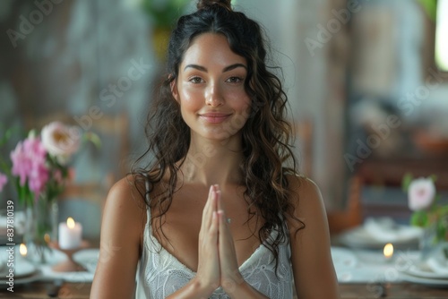 Woman sits table hands air