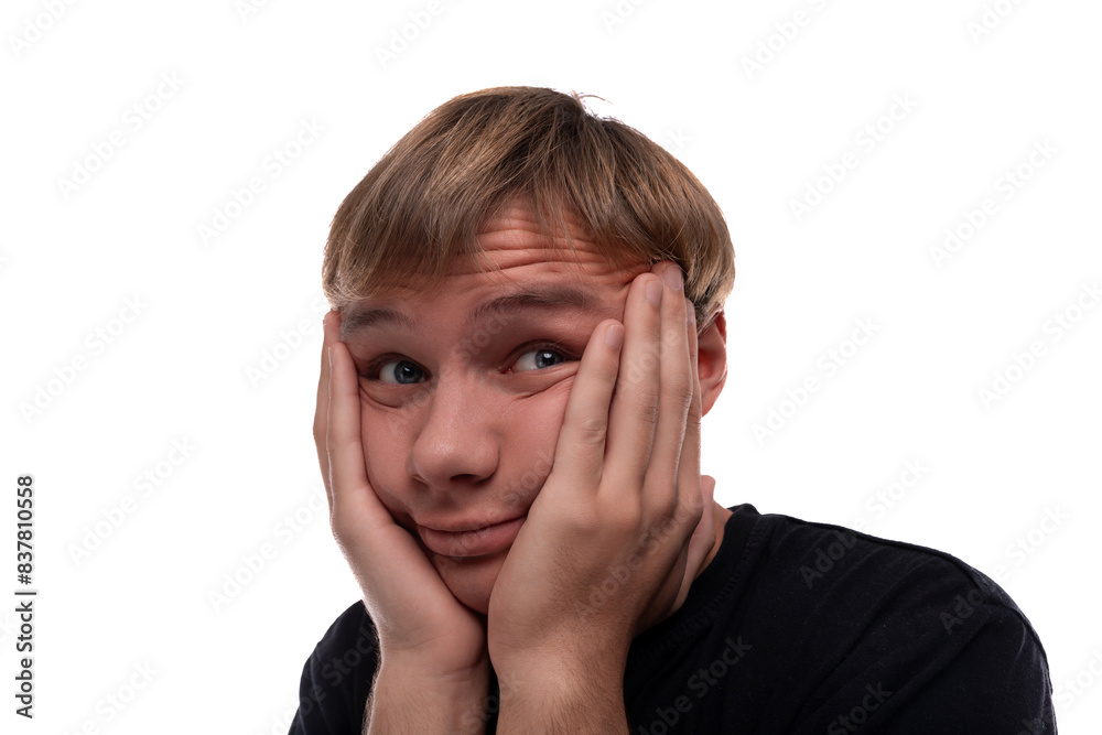 Teen boy dressed in a black t-shirt is excited and puzzled Teen boy dressed in a black t-shirt is excited and puzzled