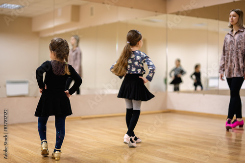 Young Girls Attending Dance Class with Female Instructor in Studio