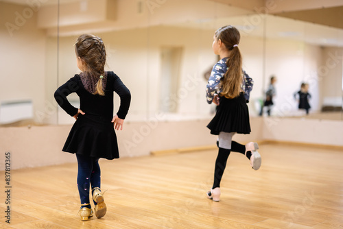 Young Girls Practicing Dance Moves in a Dance Studio With Mirrors