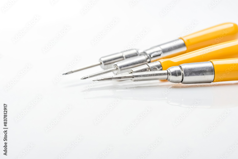 Three Yellow and Silver Tools on White Background