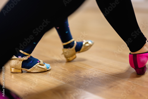 Close-Up of Tap Dance Shoes on Wooden Floor in Dance Studio photo