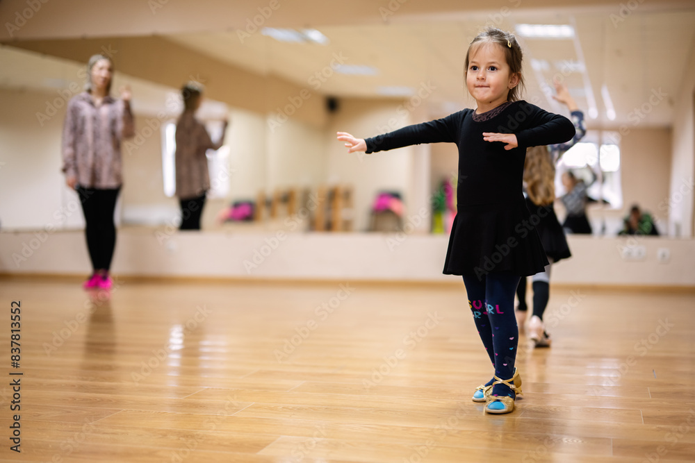 Young Girl Practicing Ballet in Dance Studio with Instructor Observing