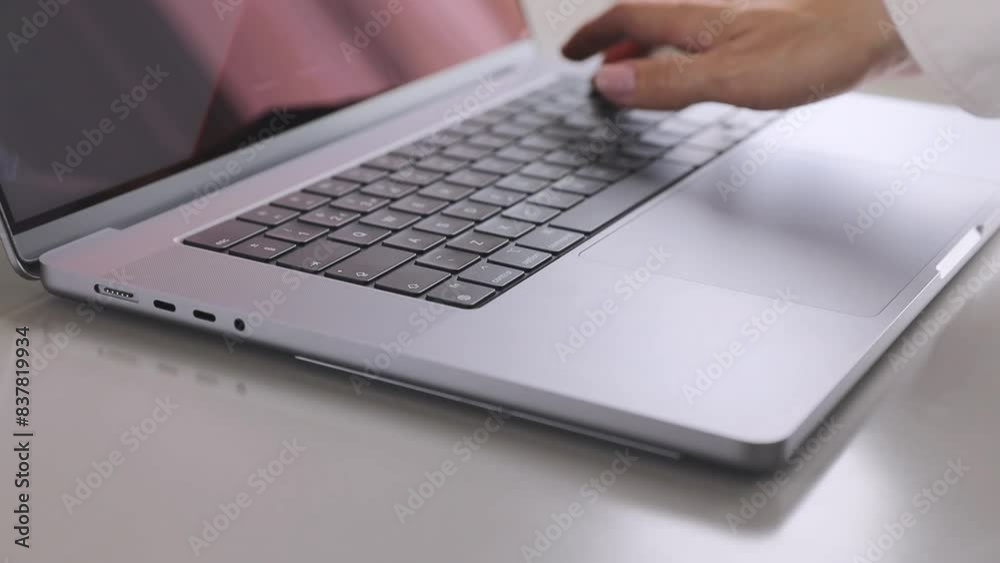 Hand typing on a laptop keyboard, a close up view. Concept of education, technology