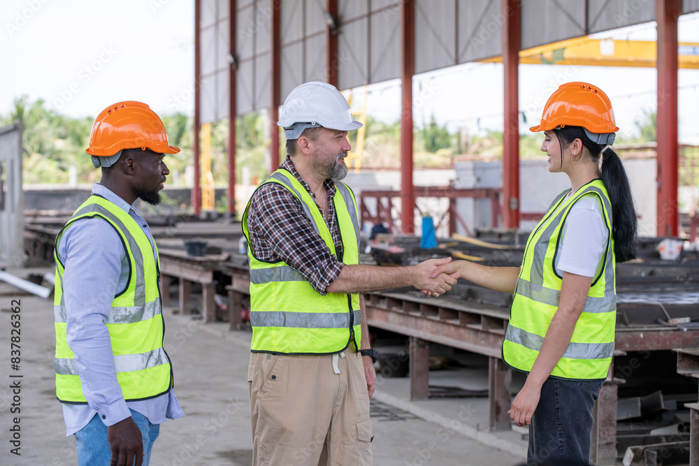 Engineers with foreman worker show hand team cooperated , congratulating successful at work after meeting on construction site teamwork professional architecture concept. Engineers with foreman worker show hand team cooperated , congratulating successful at work after meeting on construction site teamwork professional architecture concept.