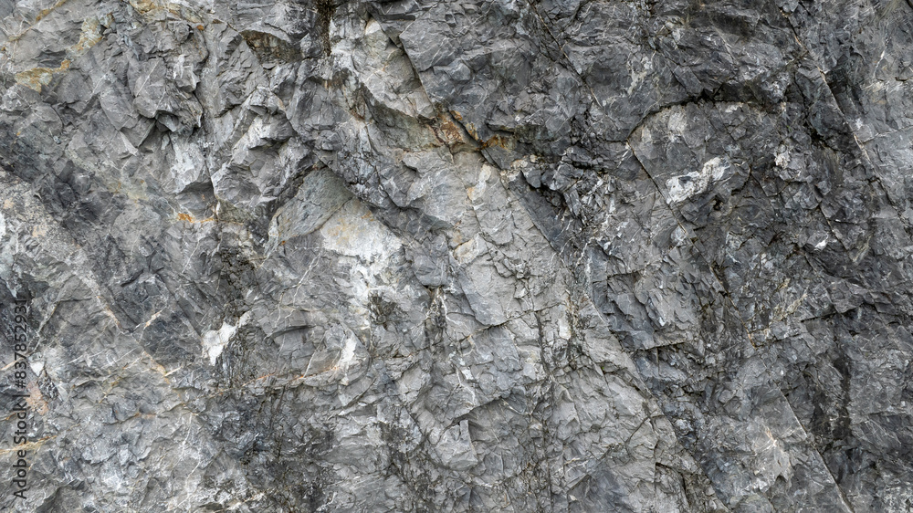 Fototapeta premium cracked black stone surface texture background.