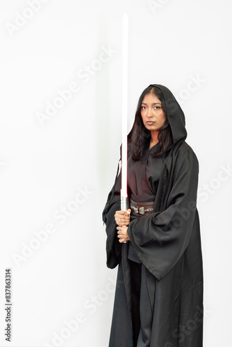 Sci-fi fantasy warrior woman cosplayer in a black robe holding a saber on a white background