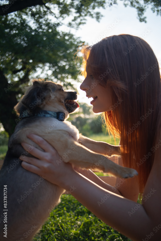 Young woman playing with pet dog outdoor closeup Young woman playing with pet dog outdoor closeup