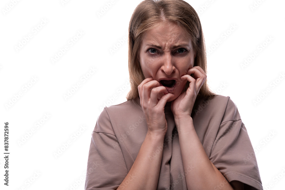 Portrait of a scared Caucasian blond woman in a T-shirt Portrait of a scared Caucasian blond woman in a T-shirt