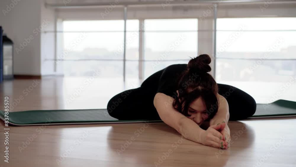 Attractive fit woman stretching in gym before her workout, female fitness yoga routine concept. Flexible female practicing yoga in studio. Fitness concept Attractive fit woman stretching in gym before her workout, female fitness yoga routine concept. Flexible female practicing yoga in studio. Fitness concept