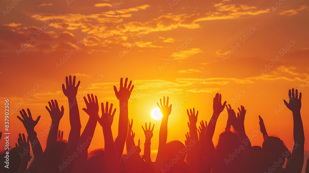A group of people raised their hands. At the concert A group of people raised their hands. At the concert