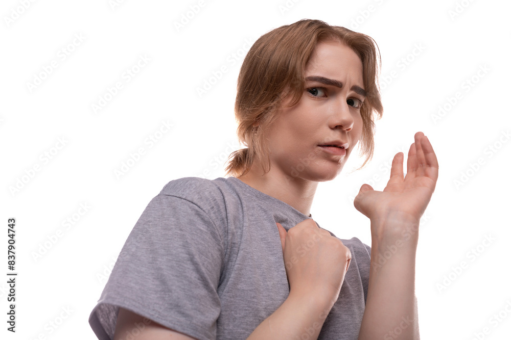 A surprised teenage girl with light brown hair looks warily A surprised teenage girl with light brown hair looks warily