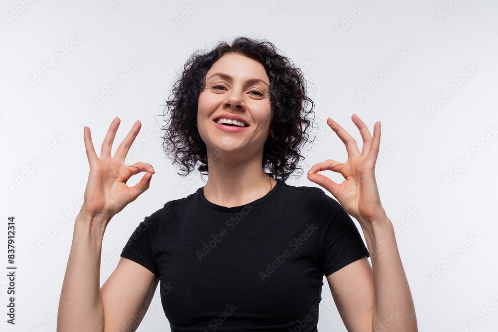 Joyful brunette with curly hairstyle wearing a basic t-shirt Joyful brunette with curly hairstyle wearing a basic t-shirt