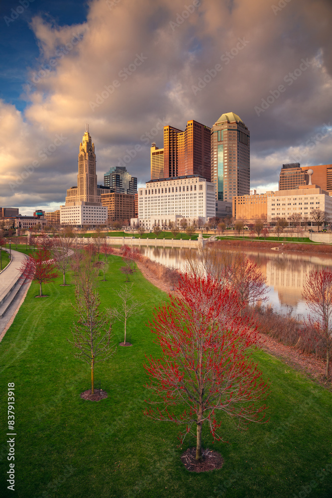 Columbus, Ohio, USA. Cityscape image of Columbus , Ohio, USA downtown skyline with reflection of the city in the Scioto River at spring sunset.
