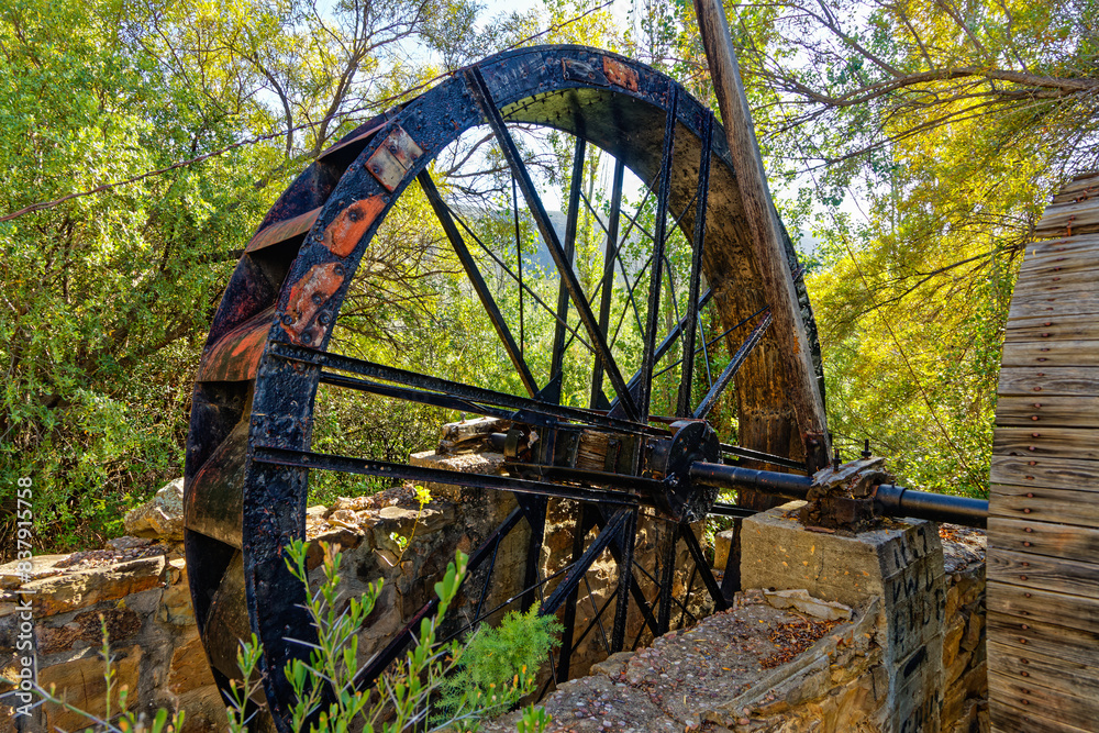 Old cast iron waterwheel mounted on shaft near Van Wyksdorp in the Little Karoo, Western Cape, South Africa Old cast iron waterwheel mounted on shaft near Van Wyksdorp in the Little Karoo, Western Cape, South Africa