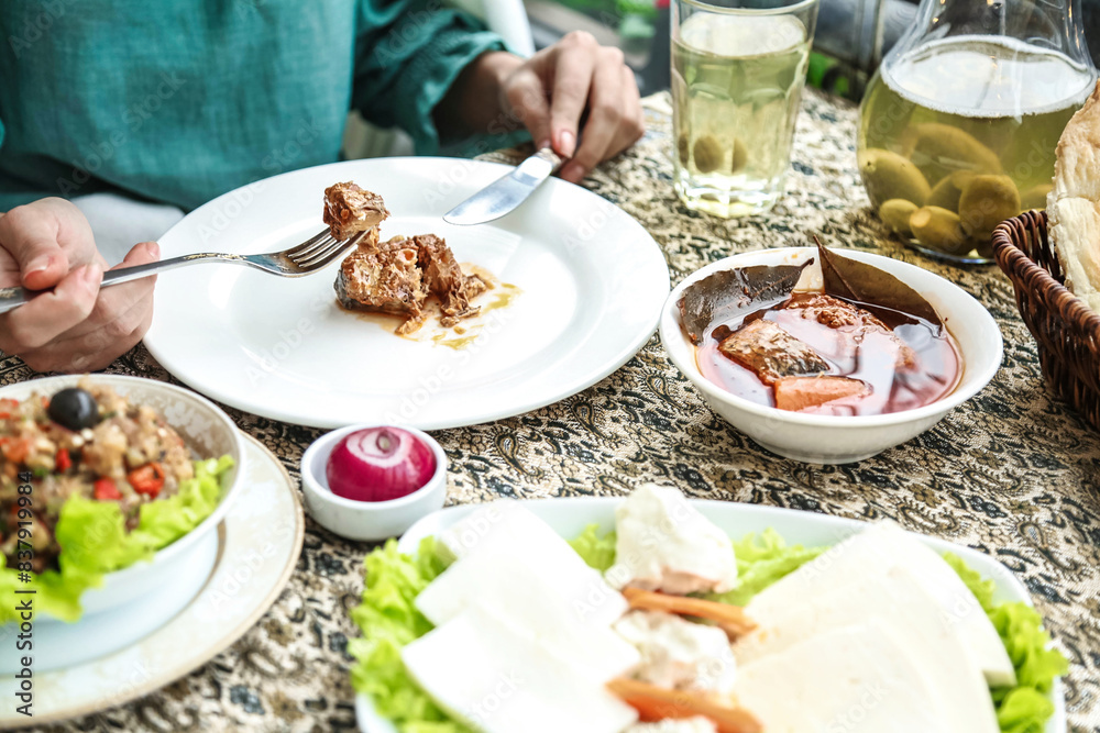 Person Sitting at Table With Plates of Food Person Sitting at Table With Plates of Food