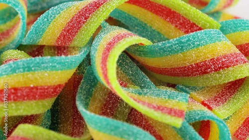 Rainbow sour jelly candies strips in sugar sprinkle.