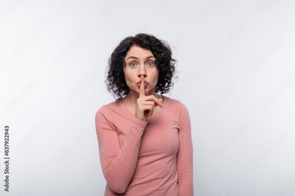 Smart cunning European adult woman with curls on white background with copy space Smart cunning European adult woman with curls on white background with copy space