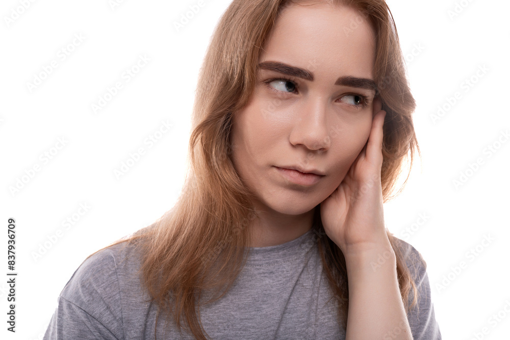 Teenage girl with blond hair doubts on a white background Teenage girl with blond hair doubts on a white background