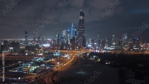 Wallpaper Mural Night cityscape, illuminated and flashing lights skyscrapers. Kuwait City downtown. Drone crane. Torontodigital.ca