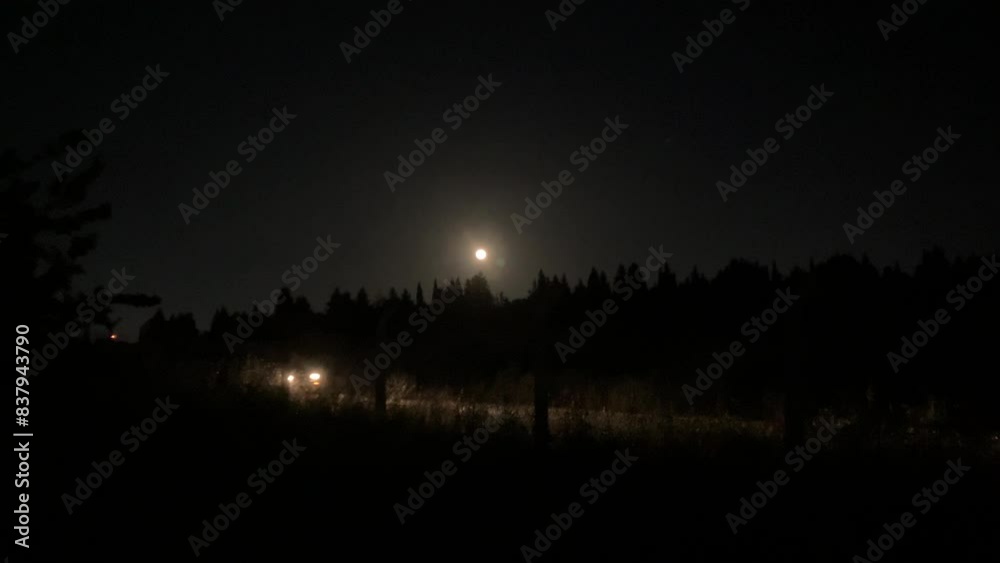 Scary atmosphere, car slowly passing on a dangerous road at nighttime Scary atmosphere, car slowly passing on a dangerous road at nighttime