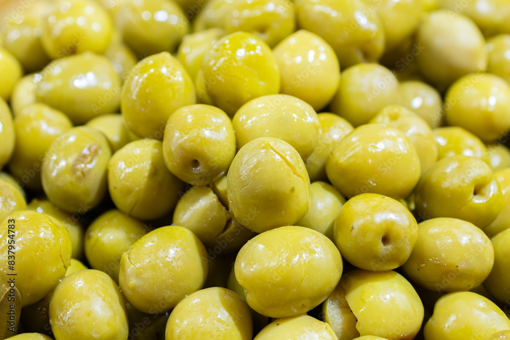 Split green olives background. Spanish appetizer