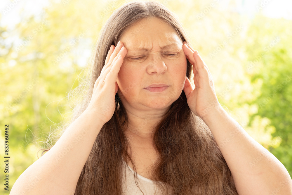 diseased mature woman experiences severe headache, holding head, Hot flashes during menopause, Decreased memory and concentration, exhausted, menopause, midlife crisis diseased mature woman experiences severe headache, holding head, Hot flashes during menopause, Decreased memory and concentration, exhausted, menopause, midlife crisis