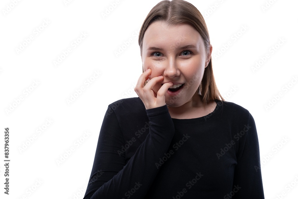 European joyful schoolgirl wearing a black turtleneck on a white studio background European joyful schoolgirl wearing a black turtleneck on a white studio background