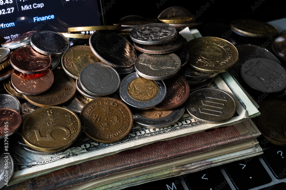 Pile of various coins on the stack of various banknotes Pile of various coins on the stack of various banknotes