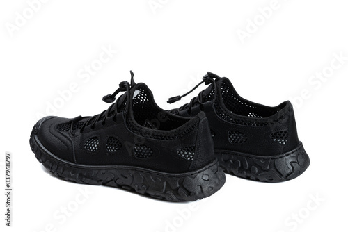 black ventilated sports shoes for men on white background © Freer