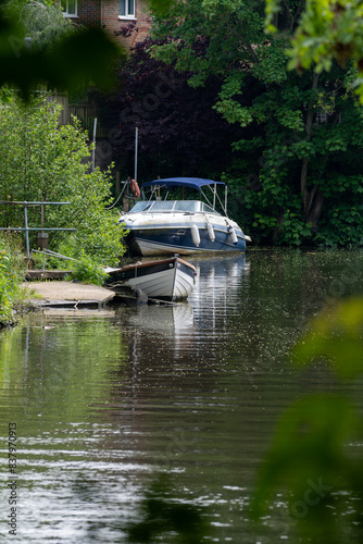 Summer Serenity: Boating on a Tranquil Canal in a Lush Green City