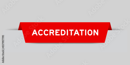 Red color inserted label with word accreditation on gray background