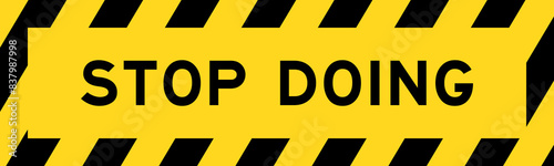 Yellow and black color with line striped label banner with word stop doing